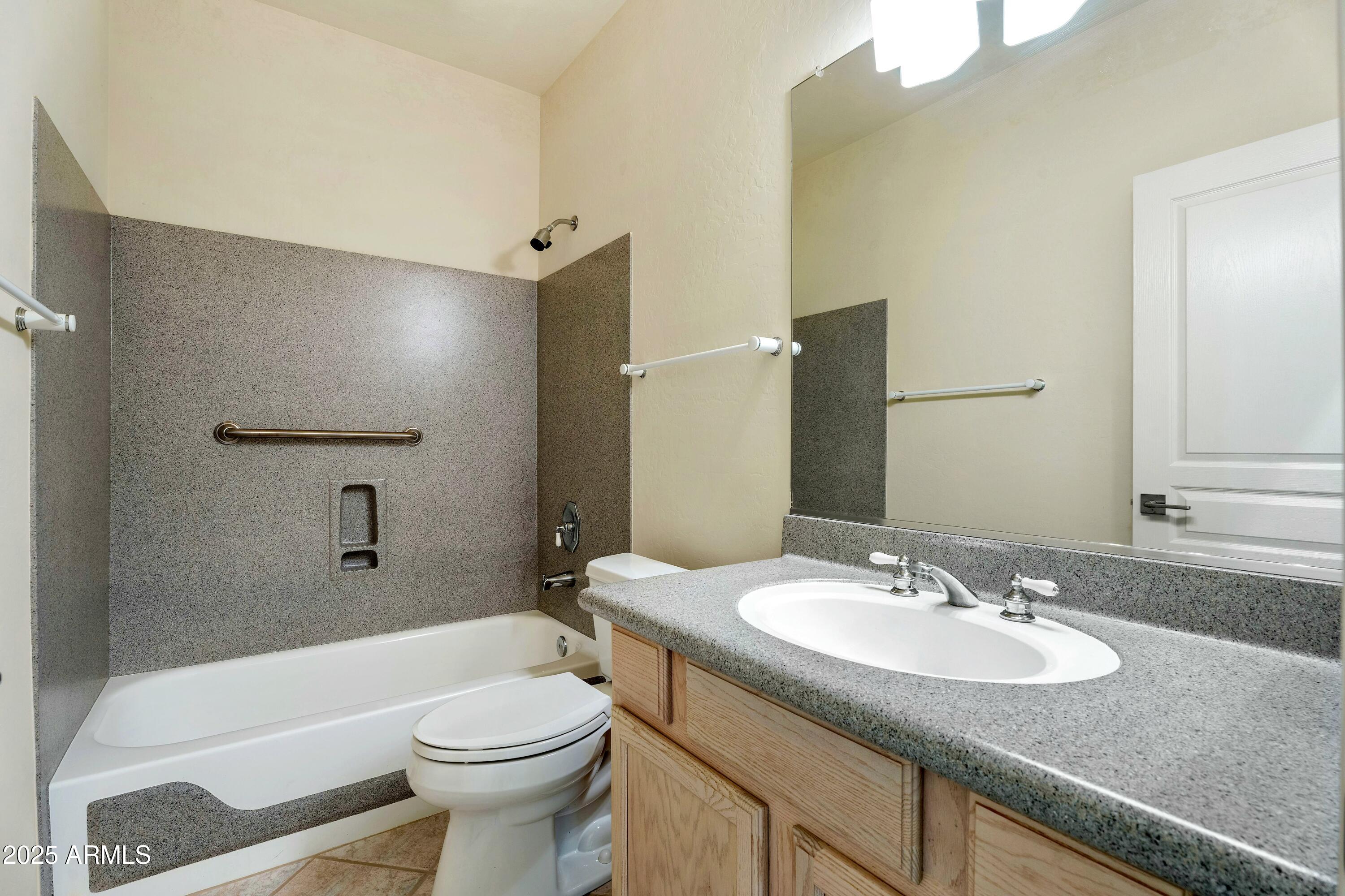 3830 East Carter Drive Phoenix, AZ 85042 - Photo 20 of 30 a bathroom with a granite countertop sink toilet and shower