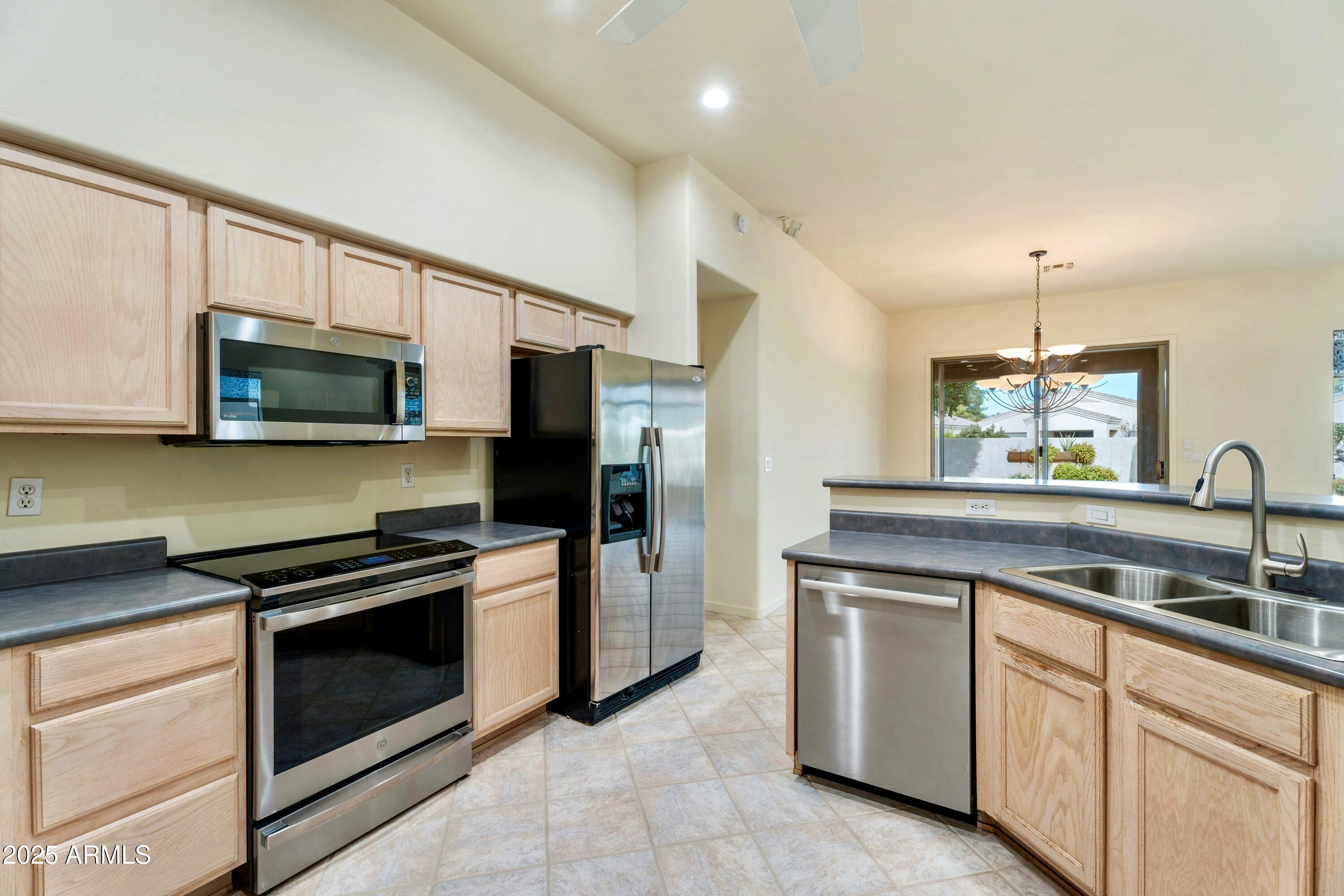 3830 East Carter Drive Phoenix, AZ 85042 - Photo 5 of 30 a kitchen with a sink stove and microwave