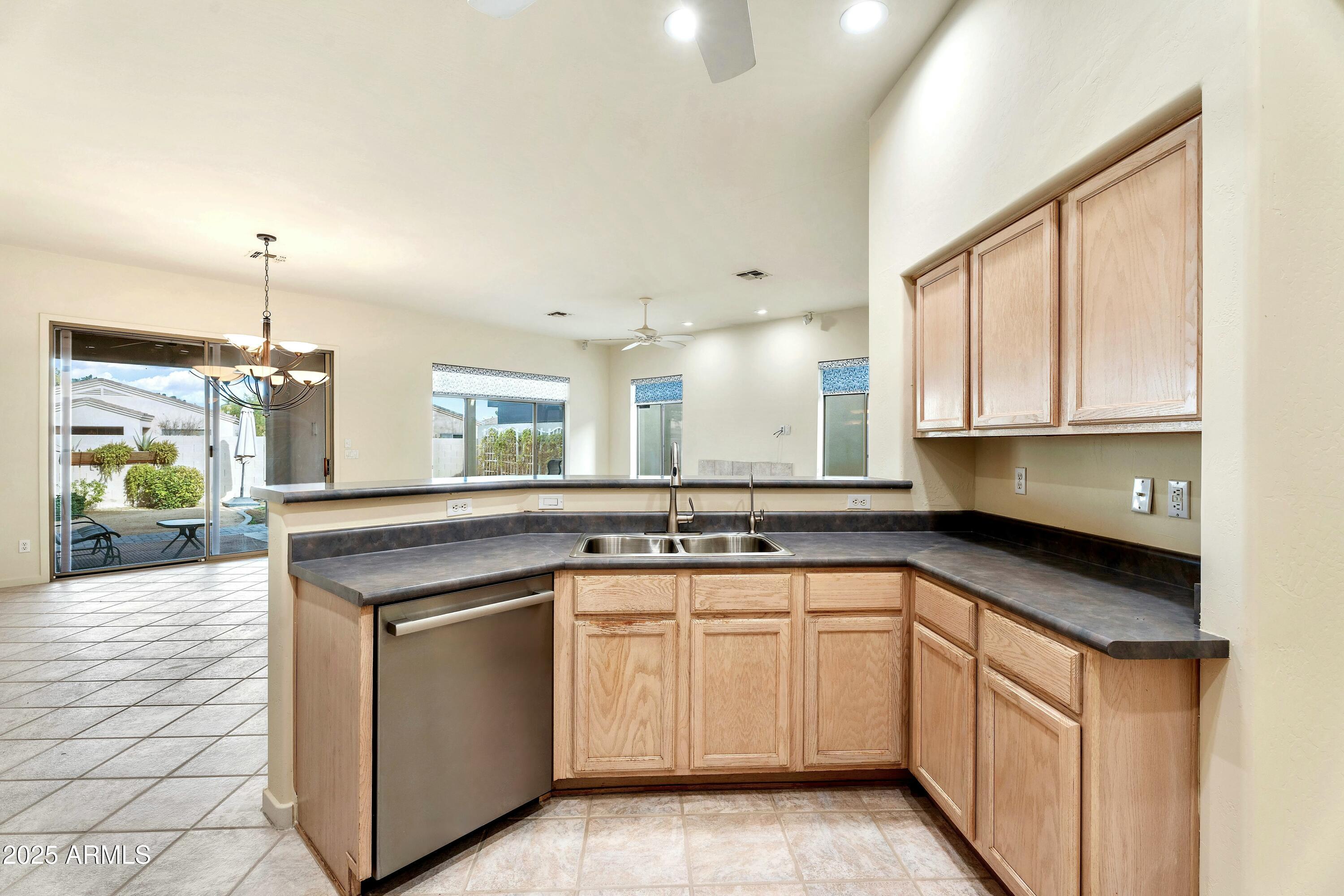 3830 East Carter Drive Phoenix, AZ 85042 - Photo 7 of 30 a kitchen with a sink stove and cabinets