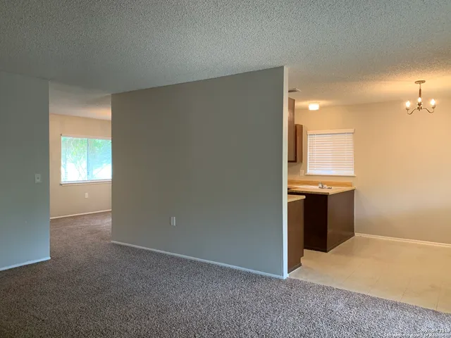 an empty room with a kitchen and a sink