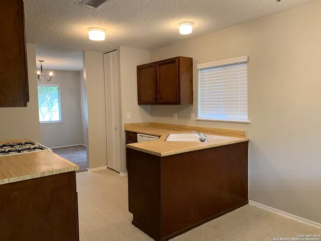 a kitchen that has a sink and a stove in it