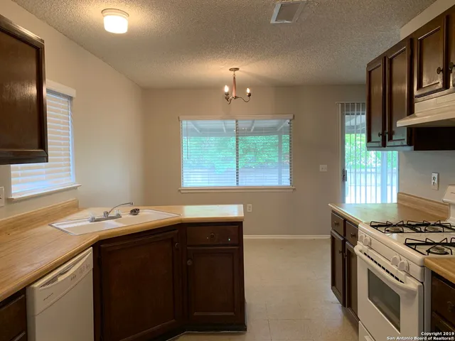 a kitchen with a sink stove and microwave
