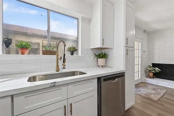 a kitchen with a sink and a refrigerator