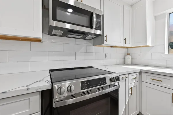 a kitchen with a stove and a microwave