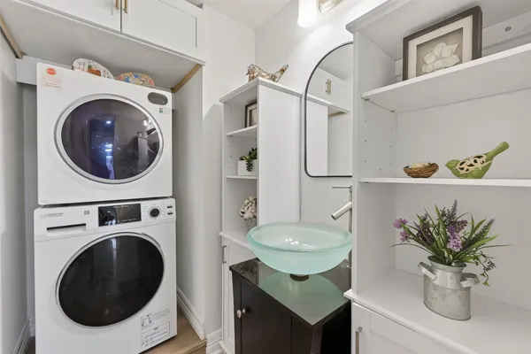 a bathroom with a sink a washer and dryer