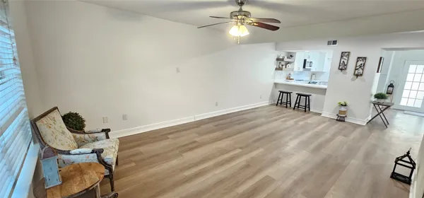 a view of a livingroom with furniture and a ceiling fan