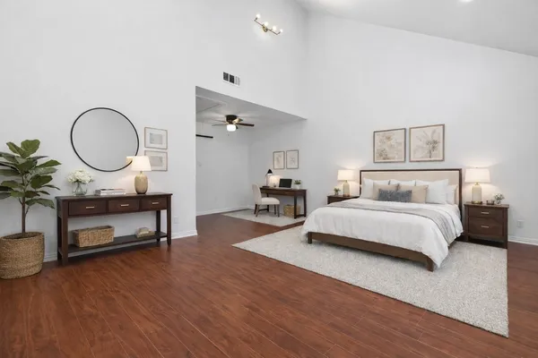 a bedroom with bed and a chandelier