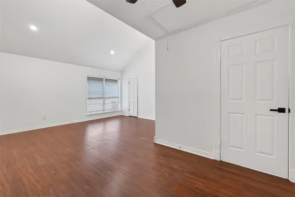 a view of wooden floor and windows in a room