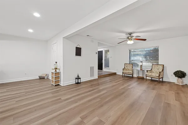 a view of a livingroom with furniture and an empty room