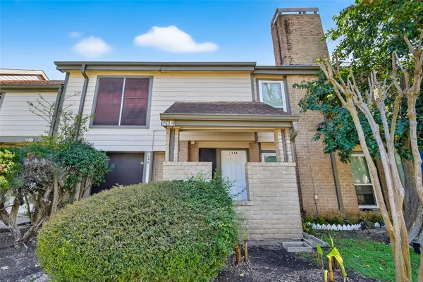 front view of a house with a small yard