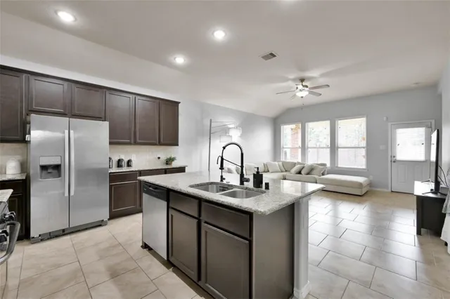a view of living room kitchen with granite countertop furniture and fireplace