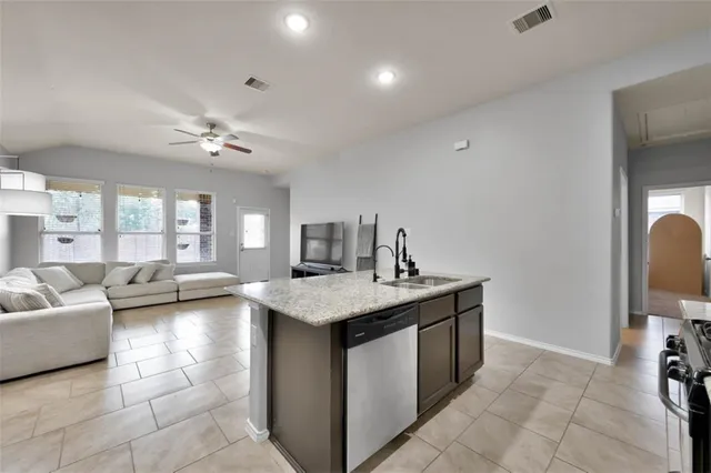a living room with furniture and kitchen view