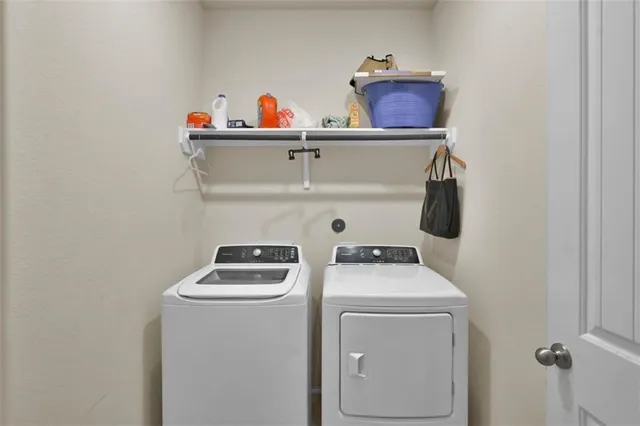 a kitchen with refrigerator and cabinets