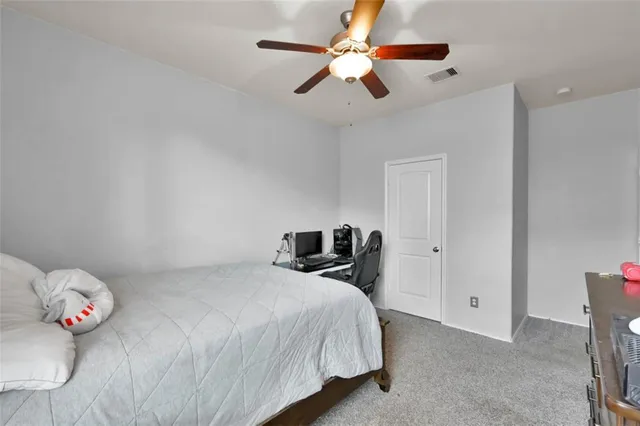 a bedroom with a large bed and a flat screen tv