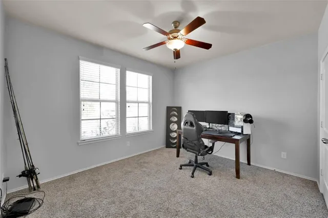 a bedroom with a bed and a ceiling fan
