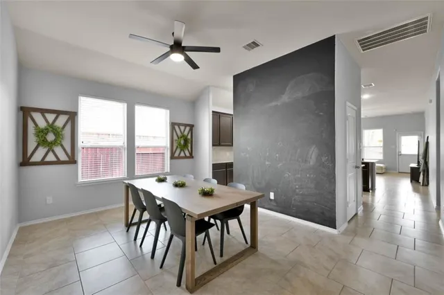 a dining room with furniture and window