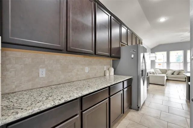 a kitchen with a sink a counter top space and stainless steel appliances