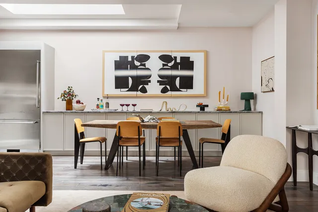 a living room with stainless steel appliances kitchen island granite countertop furniture and a large window