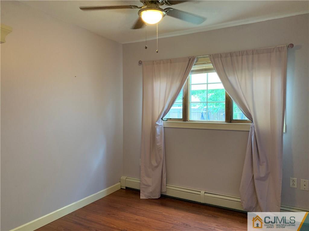 34 Windsor Road Edison, NJ 08817 - Photo 12 of 15 an empty room with wooden floor and windows