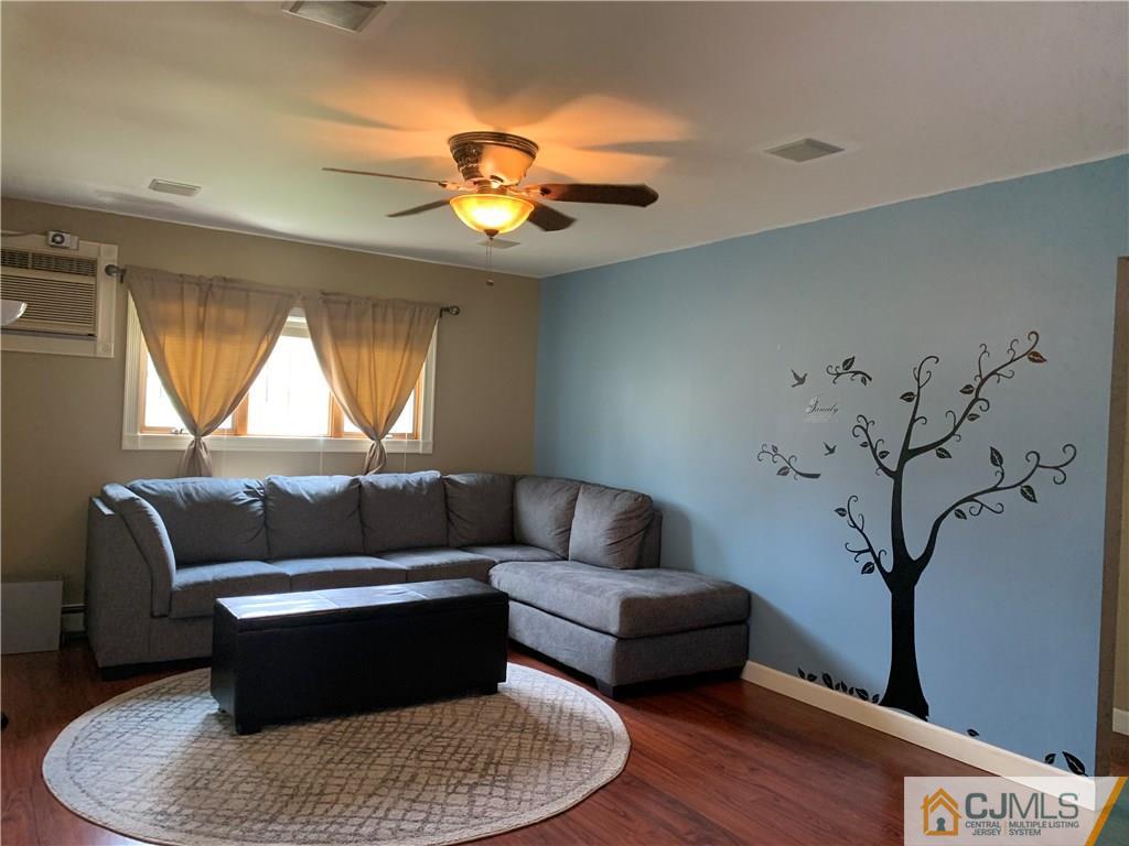 34 Windsor Road Edison, NJ 08817 - Photo 4 of 15 a living room with furniture and a large window