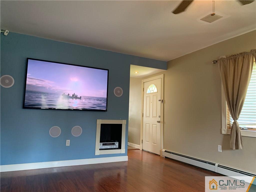 34 Windsor Road Edison, NJ 08817 - Photo 6 of 15 a view of a livingroom with wooden floor and a flat screen tv