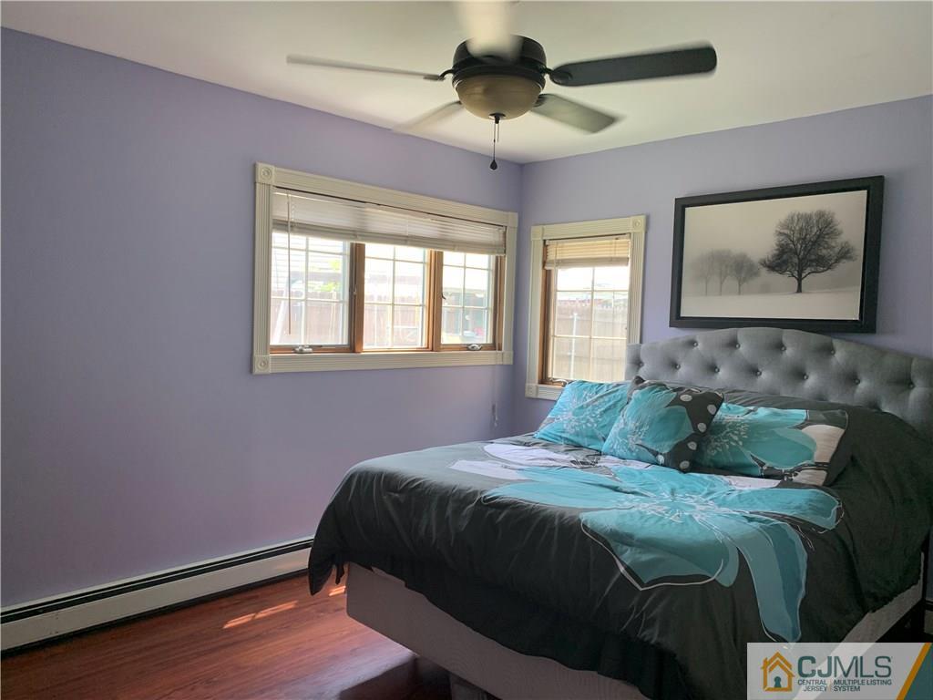 34 Windsor Road Edison, NJ 08817 - Photo 9 of 15 a bedroom with a bed and wooden floor
