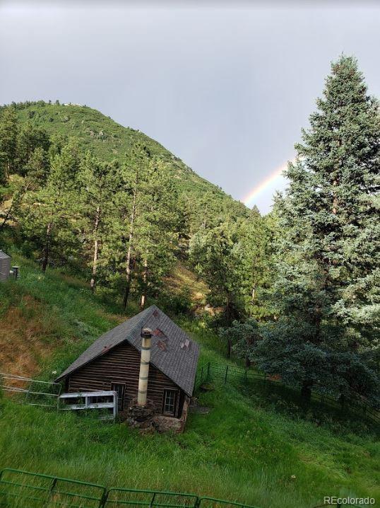 10013 McKinney Road Littleton, CO 80127 - Photo 18 of 25 a view of a house with a yard