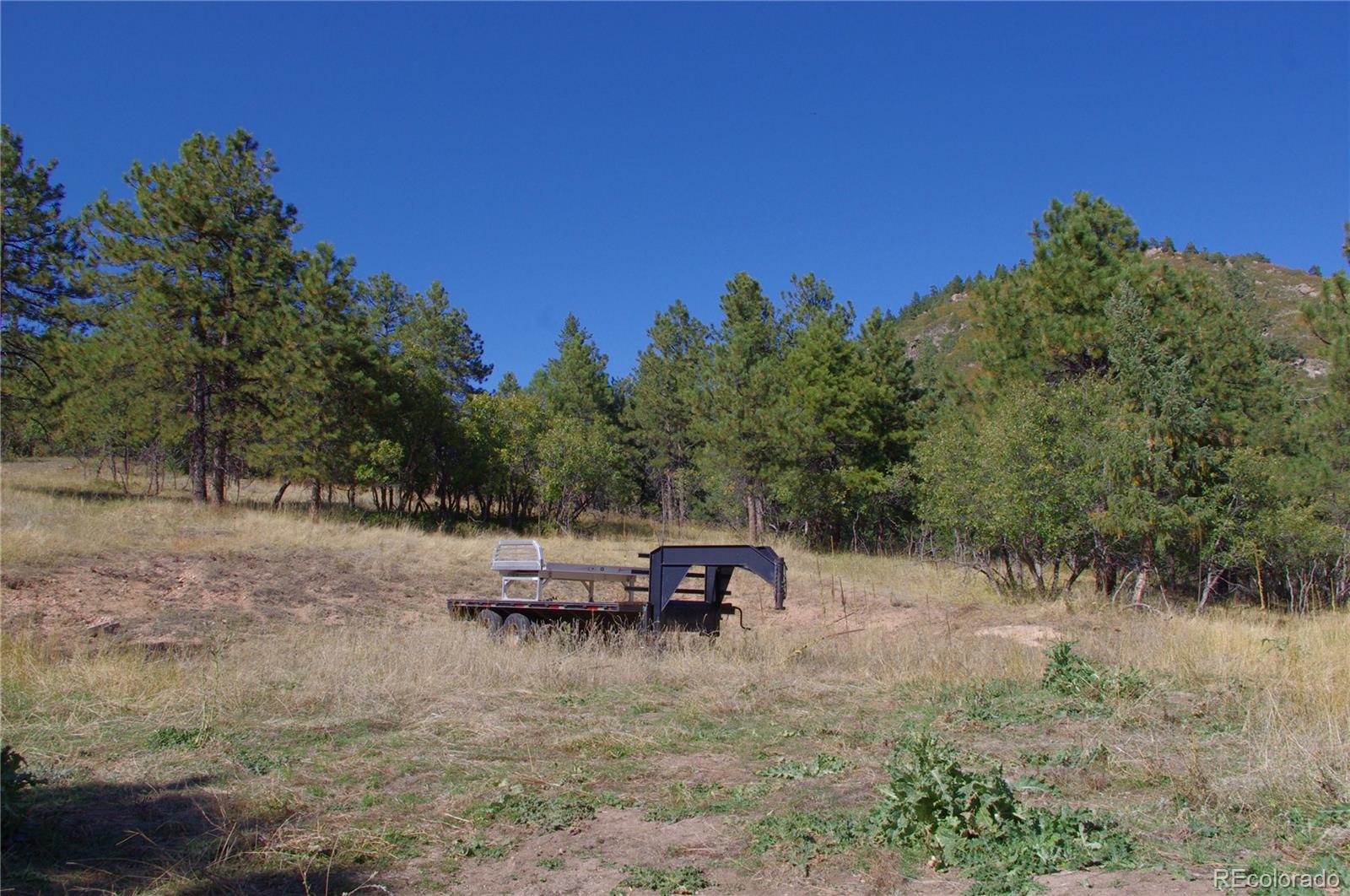 10013 McKinney Road Littleton, CO 80127 - Photo 10 of 25 a view of a lake with chairs and wooden fence