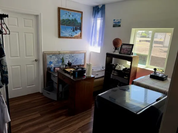 a bedroom with bed and a chandelier
