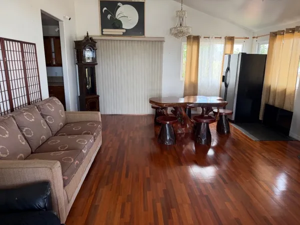 a view of a dining room with furniture and wooden floor