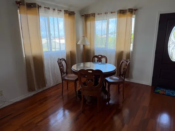 a dining room with furniture and wooden floor