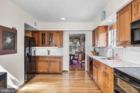 a kitchen with a sink cabinets and window