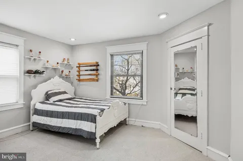 a bedroom with furniture and window