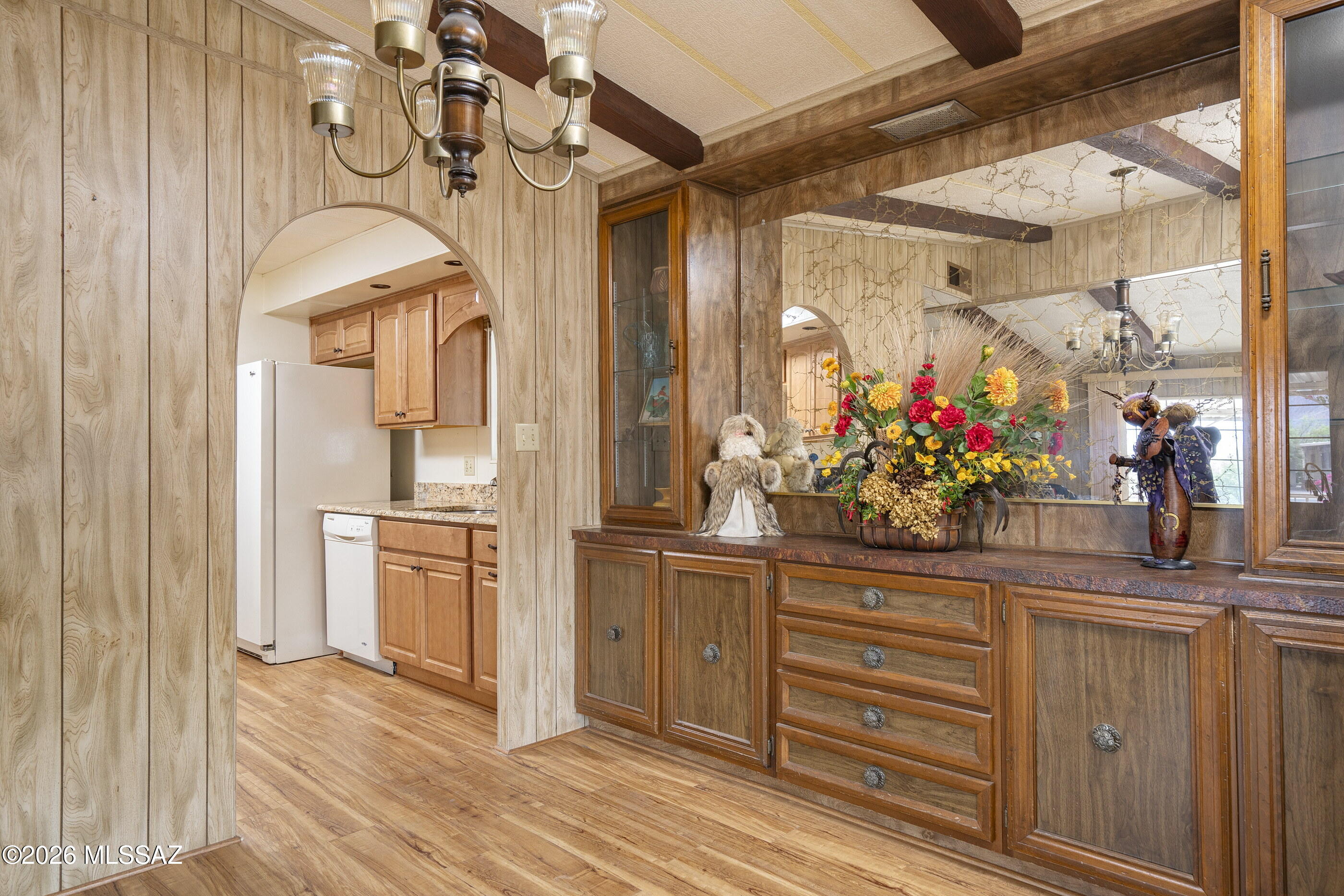 6121 West Flying M Street Tucson, AZ 85713 - Photo 10 of 25 a view of a hallway with wooden floor and chandelier