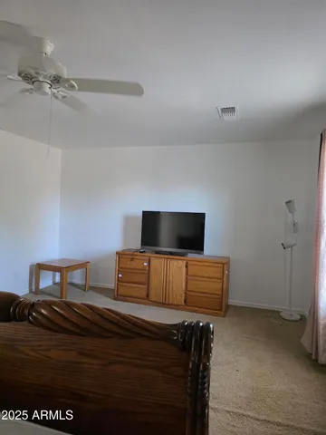 a bedroom with a bed and flat screen tv