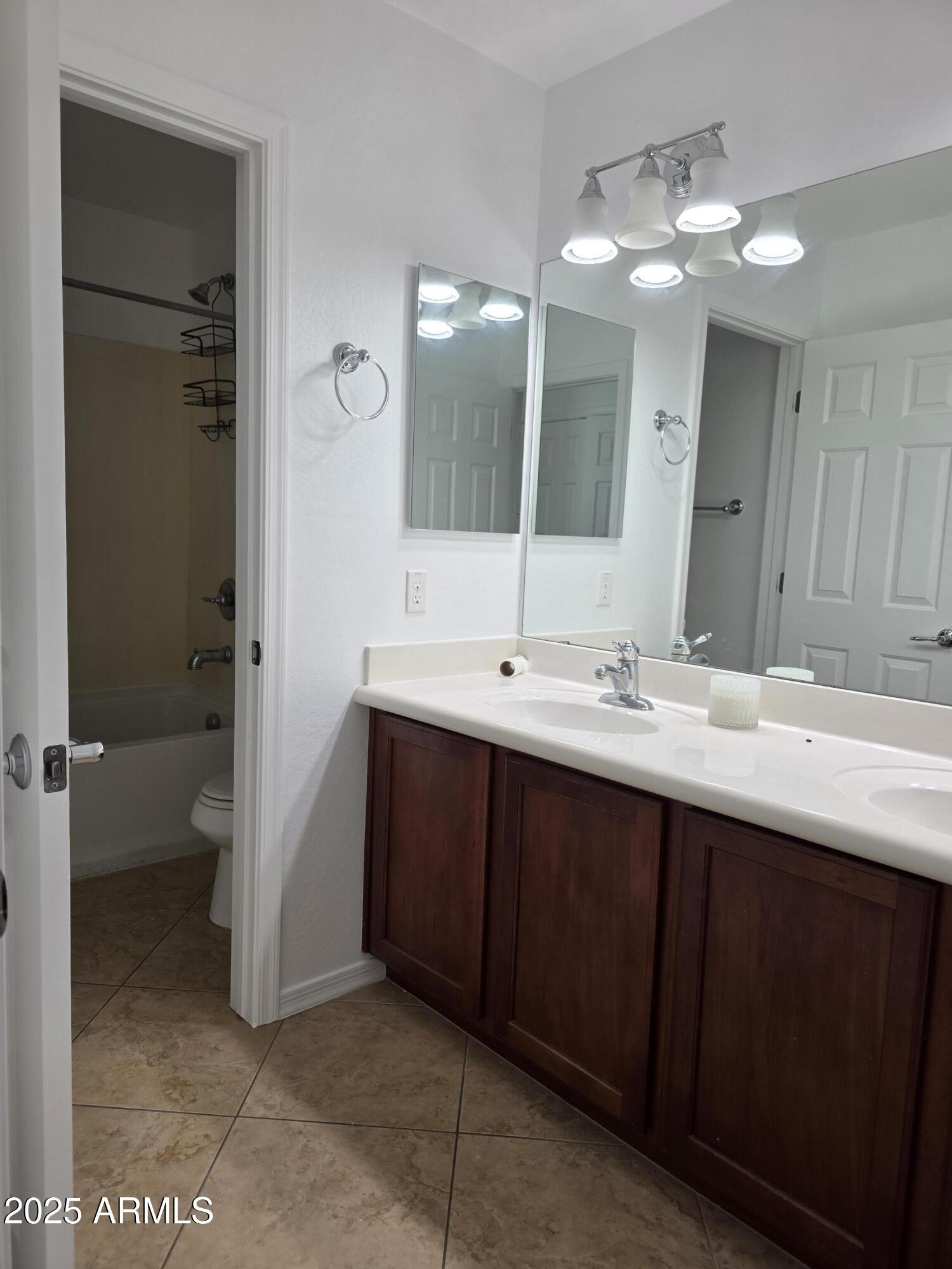 16206 North 22nd Lane Phoenix, AZ 85023 - Photo 21 of 29 a bathroom with a double vanity sink a mirror and a toilet