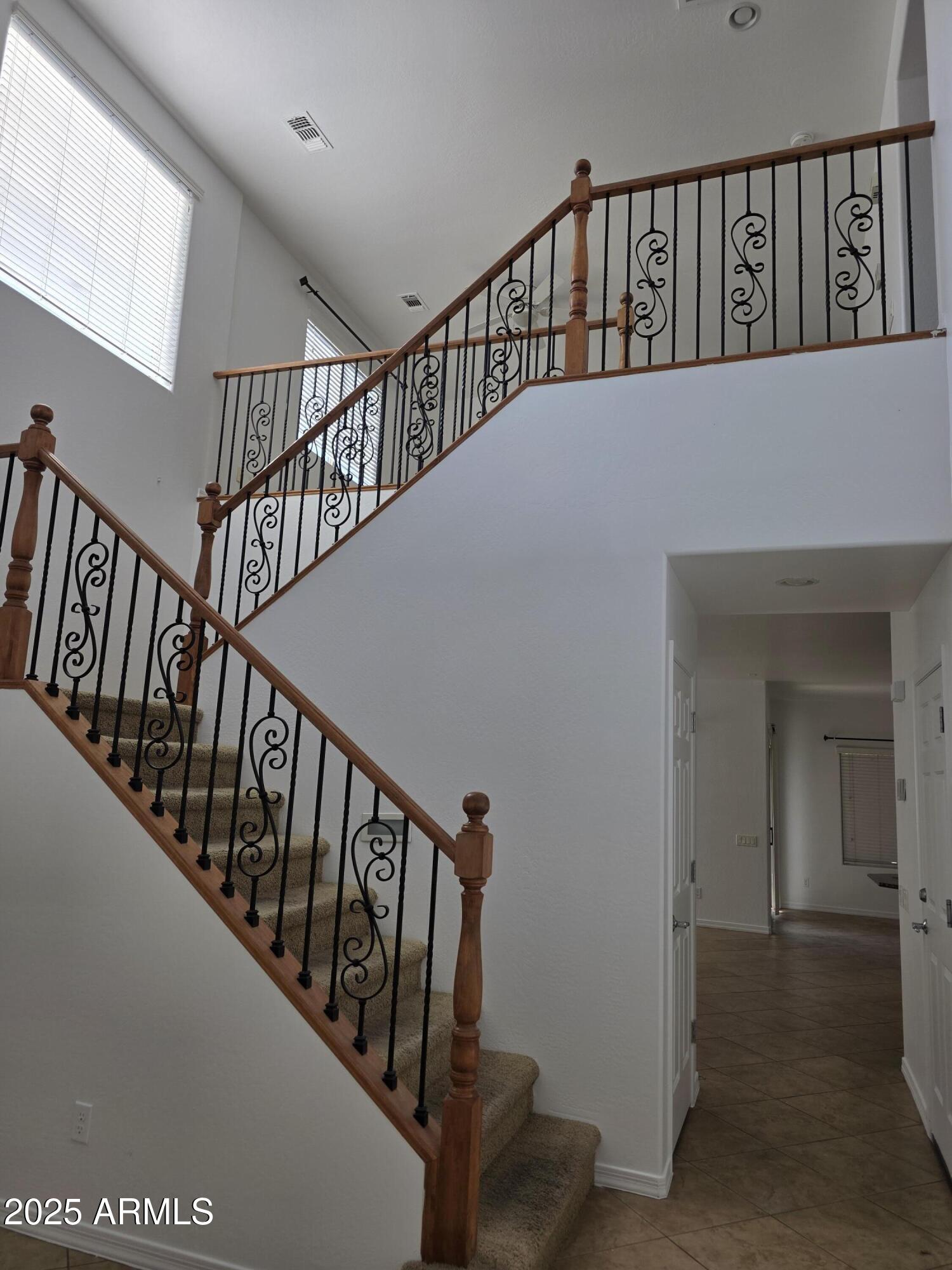 16206 North 22nd Lane Phoenix, AZ 85023 - Photo 3 of 29 a view of staircase with lots of frames on wall and a window