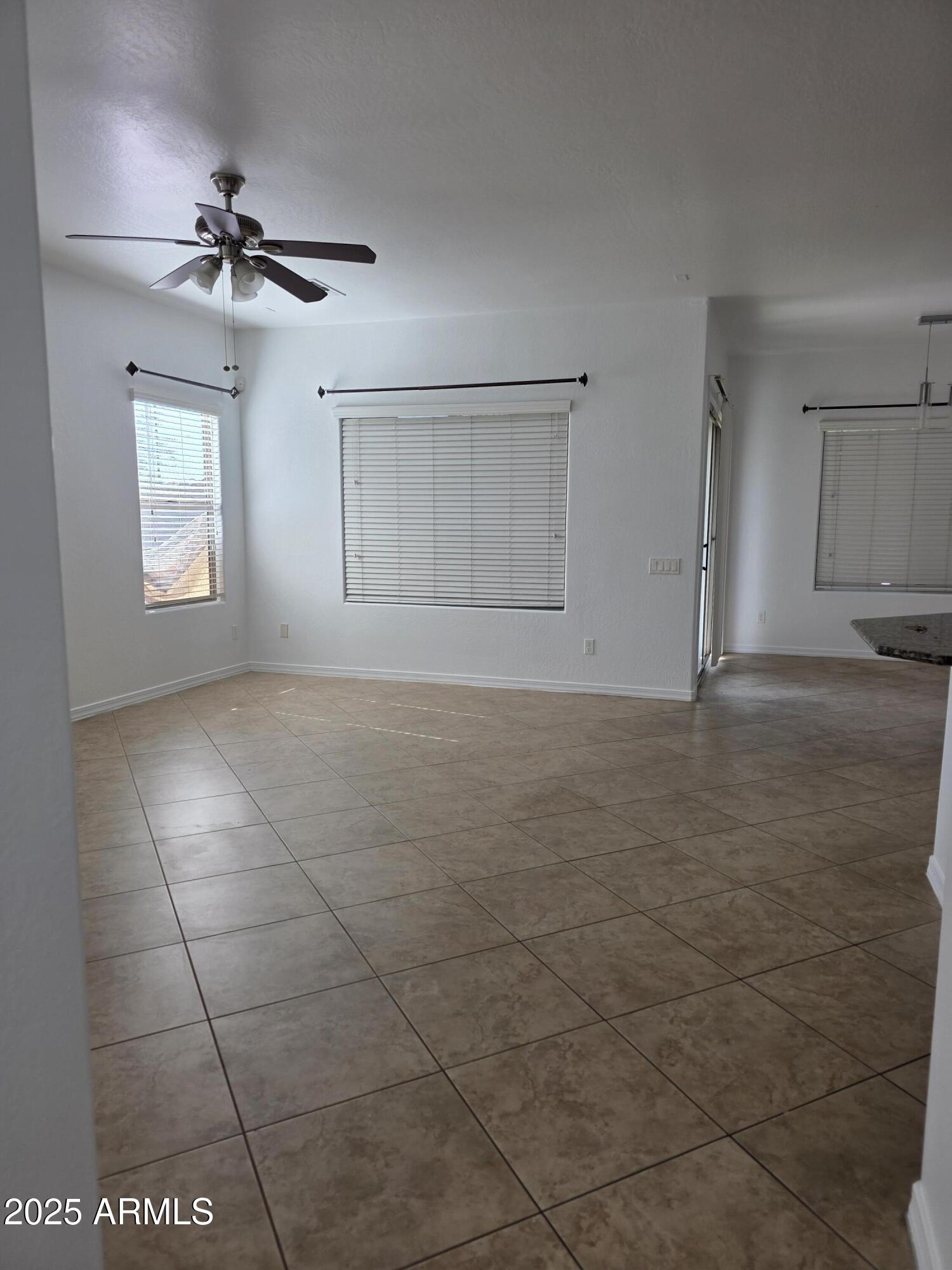 16206 North 22nd Lane Phoenix, AZ 85023 - Photo 4 of 29 a view of a livingroom with a ceiling fan and window
