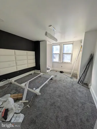 a living room with a flat screen tv and windows