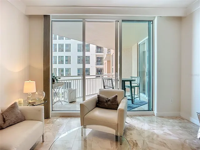a living room with furniture and a floor to ceiling window
