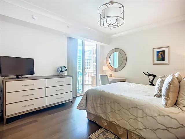 a bedroom with a bed and a chandelier