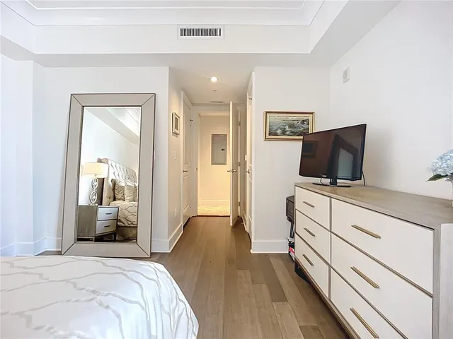 a bedroom with furniture and flat screen tv