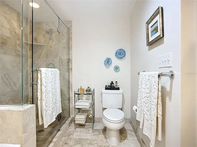 a bathroom with a toilet sink and shower