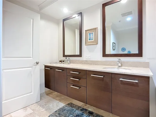 a bathroom with a double vanity sink and mirror