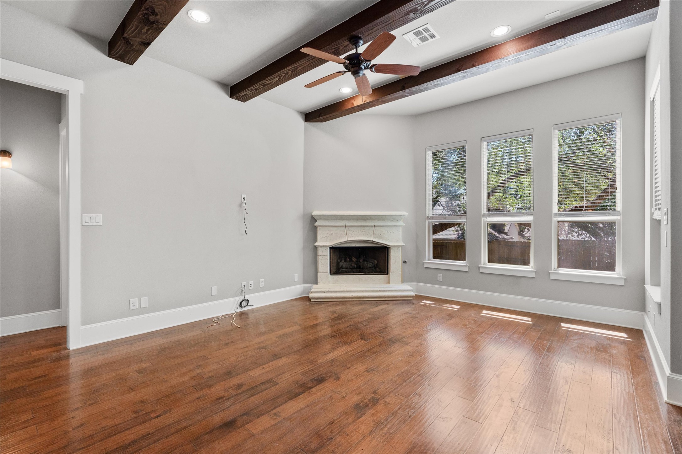 8417 Etienne Cove Austin, TX 78759 - Photo 8 of 35 A refined living space features vaulted ceilings, rich hardwood flooring, and a stately corner fireplace.