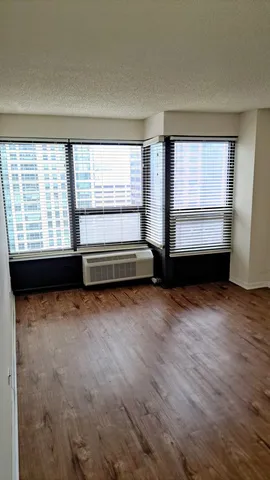 a view of a room with wooden floor