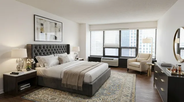 a bedroom with bed and a couch next to a window