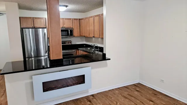 a kitchen with stainless steel appliances a refrigerator stove and microwave