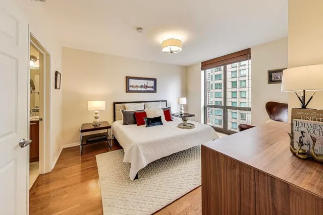 a bedroom with a bed and wooden floor