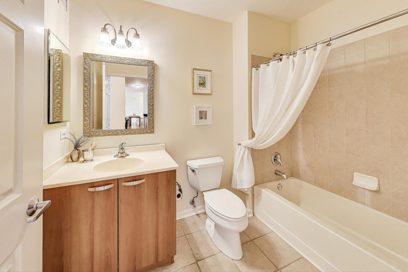 635 North Dearborn Street, Unit 2104 Chicago, IL 60654 - Photo 19 of 29 a bathroom with a sink toilet and shower